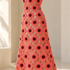 Coral pink crocheted halter dress with burgundy flower centers displayed on a white mannequin, showing fitted bodice and flared skirt